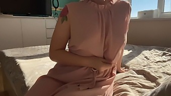 A Woman In A Soft Pink Dress Explores Her Sensual Desires